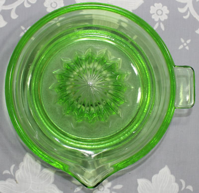 Top view of a green Jeannette Glass large saucer juicer 
