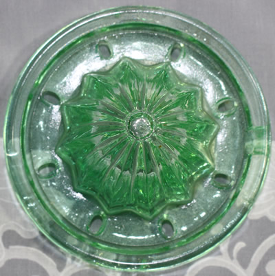 The reamer for a green U.S. Glass Company juicer (Oval holes) and jug