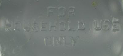 The embossed base on a Green U.S. Glass Company juicer (Oval holes) and jug