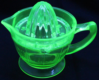 A Green U.S. Glass Company juicer (Oval holes) and jug under UV light