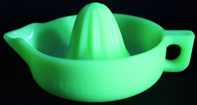 A round handle jadeite SUNKIST juicer under UV light