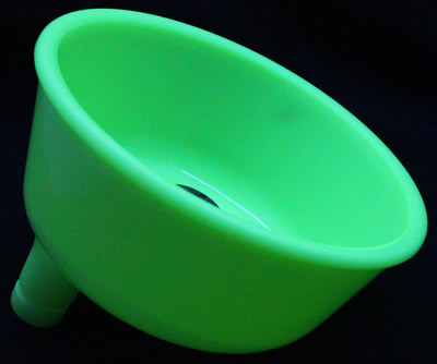 A jadeite or green milk glass juicer attachment under UV light