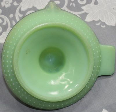 Showing the hobnail pattern on a jadeite with clear glass saucer shape juicer