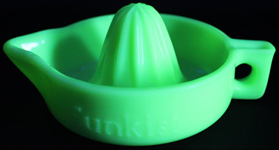 A small bottom curve handle jadeite SUNKIST juicer under UV light