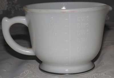 Back of a Hazel Atlas white milk glass with Green band juicer jug