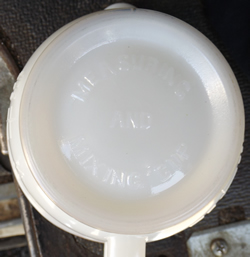 Base of a Hazel Atlas white milk glass with Green band juicer jug