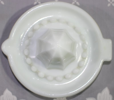 Small white milk glass juicer top view