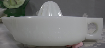 Side view of a SUNKIST white milk glass juicer