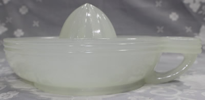 The side view of a clambroth loop handle glass juicer