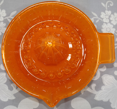 Fired on orange hobnail glass juicer top view