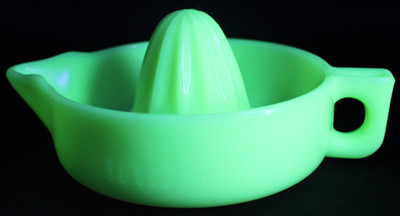 A light seville yellow straight handle Sunkist juicer under UV light