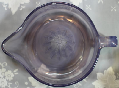 Top view of a straight handle purple glass Sunkist juicer