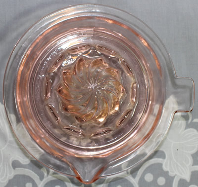 Top view of a small Hazel Atlas Pink glass saucer juicer