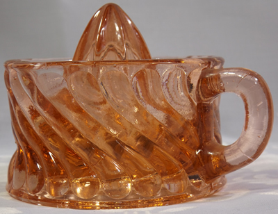 Off pink glass spiral juicer side view