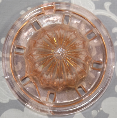 Pink U.S. Glass Company reamer with rectangular drain holes