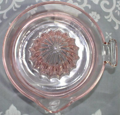 Embossed ORANGE JUICE EXTRACTOR Pink glass juicer top view