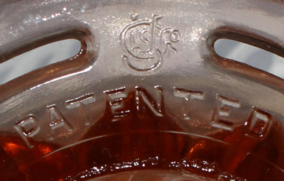 "PATENTED" and US Glass Company logo on pink 2 piece juicer 