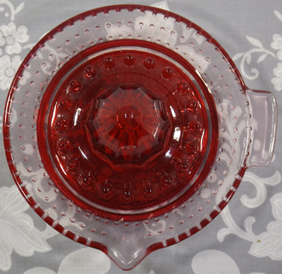 Clear glass with red baked on juicer top view