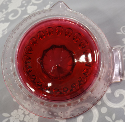 Clear glass with red baked on juicer bottom view