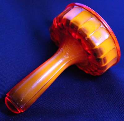 Reproduction red glass Duboe hand held juicer under UV light