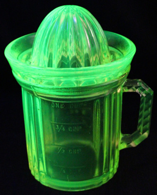 Yellow Uranium Gillespie Measuring Cup with a reamer top juicer under UV ligh