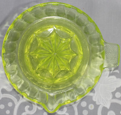 Top view of a speckled base on a panelled citron glass juicer