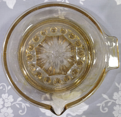 French root beer colour glass saucer juicer top view