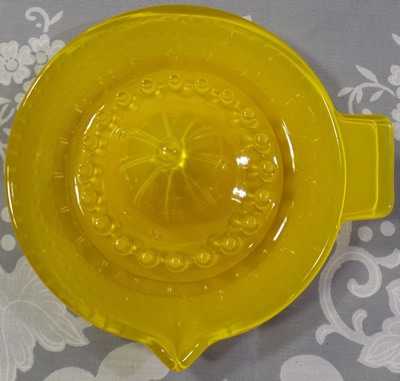 Baked on yellow hobnail glass juicer top view