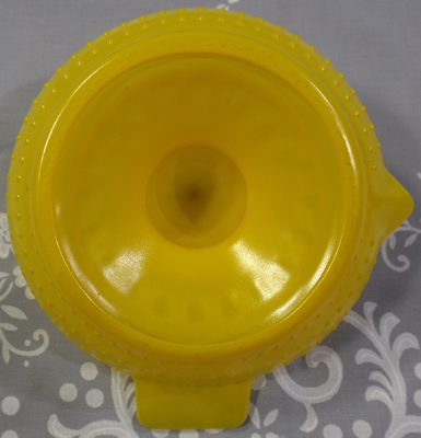 Baked on yellow hobnail glass juicer bottom view