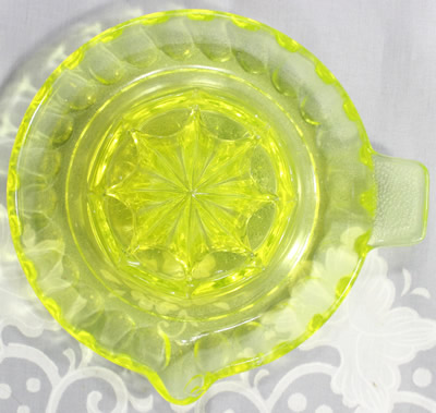Top view of a yellow uranium saucer reproduction juicer