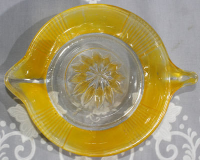 Top view of a Crown Crystal Australia fired on yellow tear drop handle juicer