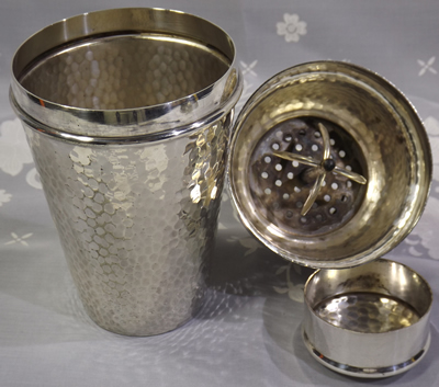 3 parts of a hammered Harrods silver plate cocktail shaker with juicer