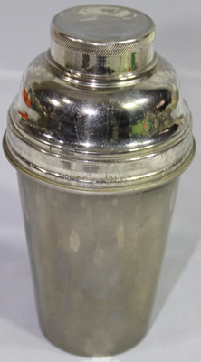A closed 7 piece stainless Steel cocktail shaker with juicer 