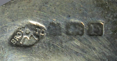 The hallmarks on the hilt of an Adie and Co Sterling Silver juicer