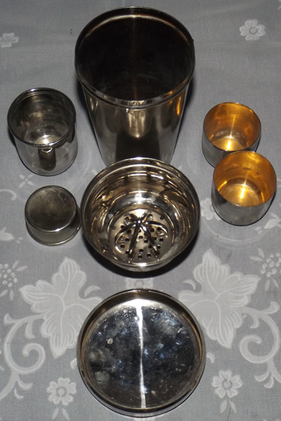 The 7 parts of a German cocktail shaker set with juicer