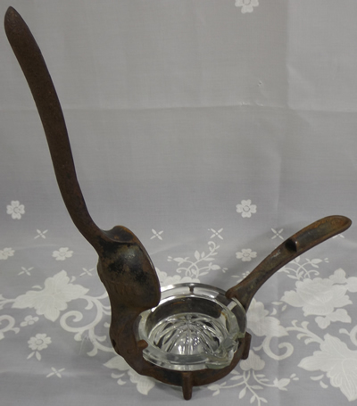 An open Williams cast iron with glass insert juicer