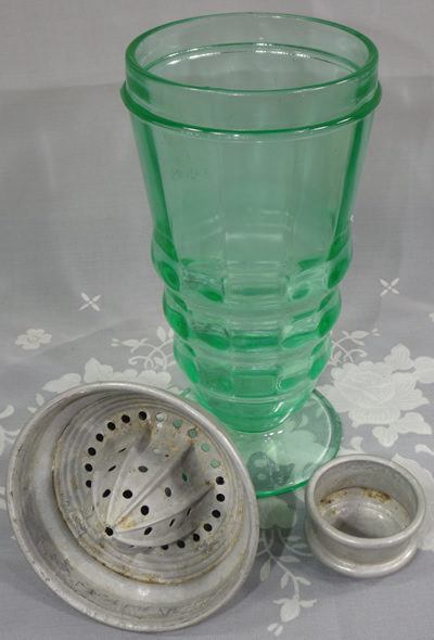 Parts of a Green Party Line cocktail shaker with aliminium juicer