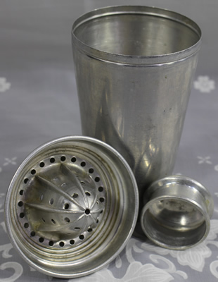 Parts of a 3 piece aluminium cocktail shaker with a juicer