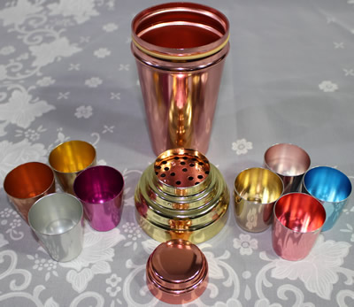 Parts of a Multicoloured anodised aluminium cocktail shaker with juicer