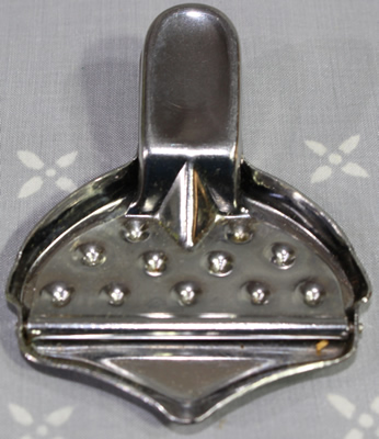 Front view of an 11 dents on inscribed 'stainless steel' squeezer