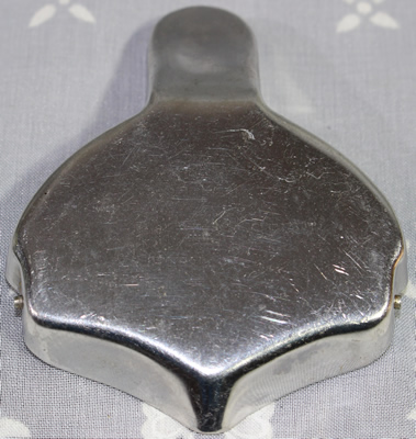 Back view of an 11 dents on inscribed 'stainless steel' squeezer