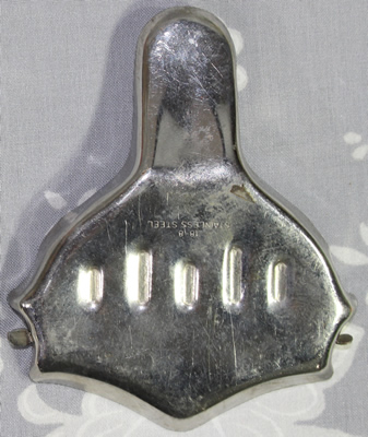 Back of a 10 dents on inscribed 'stainless steel' squeezer