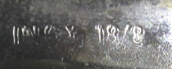 The inscribed mark on a left handed stainless steel tab handle juicer