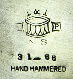 The hallmark on a Taber & Tibbits Inc.2 piece hammered silverplate juicer