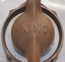 Embossed top of a King cast iron juicer