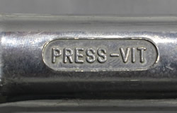 Embossed "PRESS-VIT" on an aluminium hand squeezer