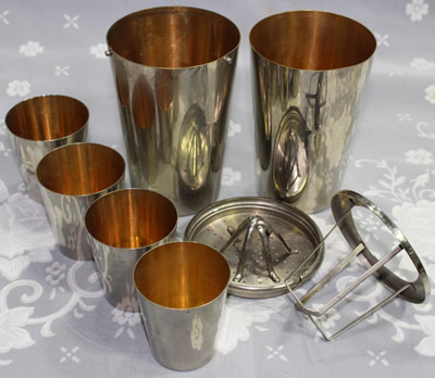 The 8 parts of a stainless steel DRGM cocktail shaker with juicer