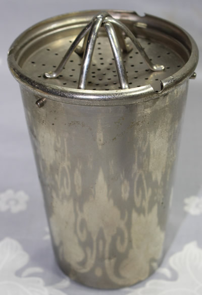 An open 8 part stainless steel DRGM cocktail shaker with juicer