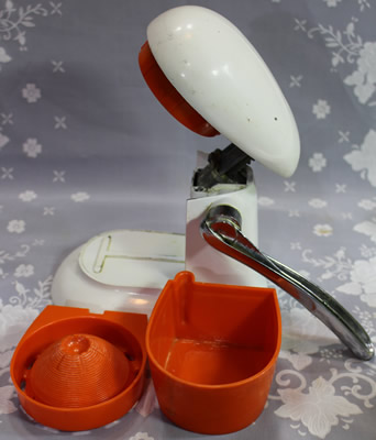 The parts of a lever iron and red plastic squeezer juicer