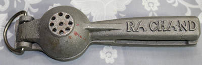 The bottom of a Ra Chand aluminium hand squeezer juicer